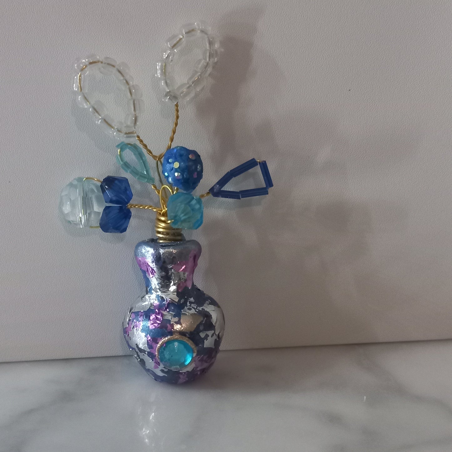 Silver and blue foil vase brooch